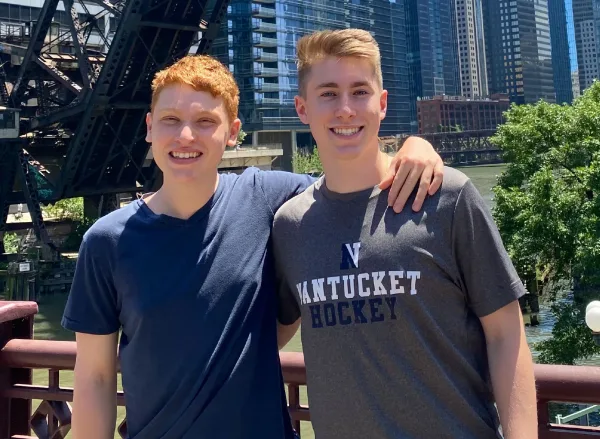 Dylan & Nick – Chicago River Dylan and Nick standing together smiling along the riverwalk in Chicago, IL.