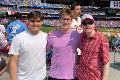 7.28.23_PhilliesGame Simon standing next to his two friends - Nick and Sebastian - at a Phillies baseball game.