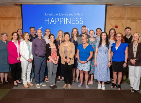 400x293_LIGroupShot Proof Positive Group standing with "Spread the Science and Skills of Happiness" in the background