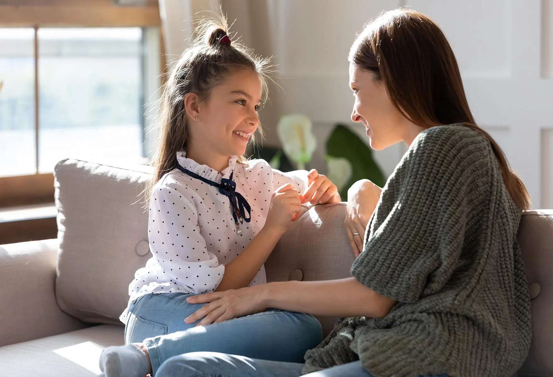 a woman and child sitting on a couch