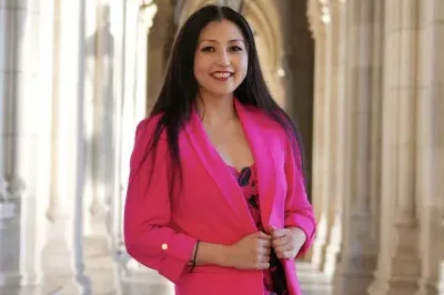 Marisa_2 Marisa is smiling wearing a pink suit jacket
