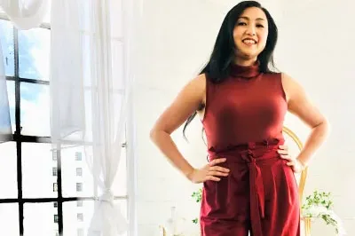 400x293_Marisa_4.29 (1) Marisa, wearing a red jumpsuit, is standing with her hands on her hips and smiling