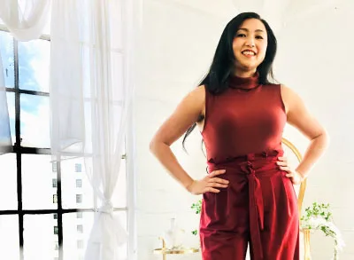 400x293_Marisa_4.29 (1) Marisa, wearing a red jumpsuit, is standing with her hands on her hips and smiling