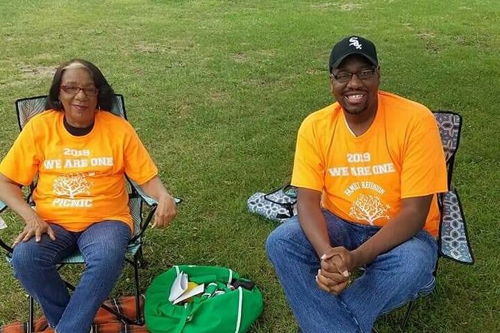 IMG_20210509_063312_444 Maurice and his mother are sitting on camping chairs in yellow shirts smiling