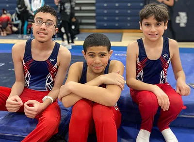 400x293_MforH_Shannon4 (1) three boys in gymnastics uniforms smile for the camera