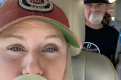 400x293_PaigePics6 Paige is sitting in her car with her sun, both are blowing bubbles with bubble gum.