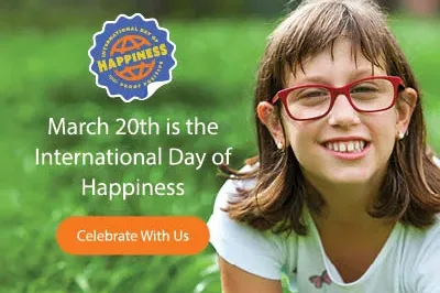 400x293_IDOHGirl2025 A young girl with brown hair and red glasses smiling with grass in the background and text over the grass that says, "March 20 is the International Day of Happiness." and an orange button with "Celebrate With Us" text on it.