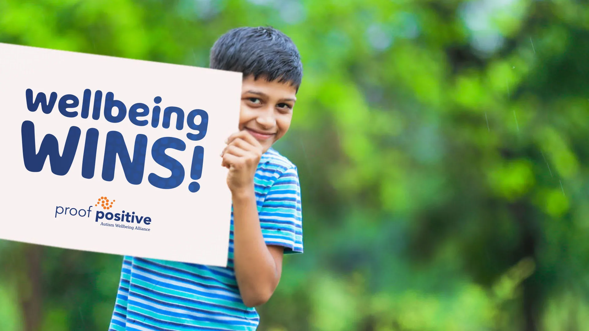 boy holding a wellbeing wins sign