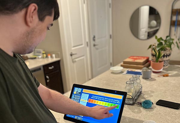 a young man taking a PERMA+ survey online
