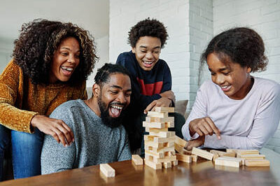 A family is playing a Jenga game together