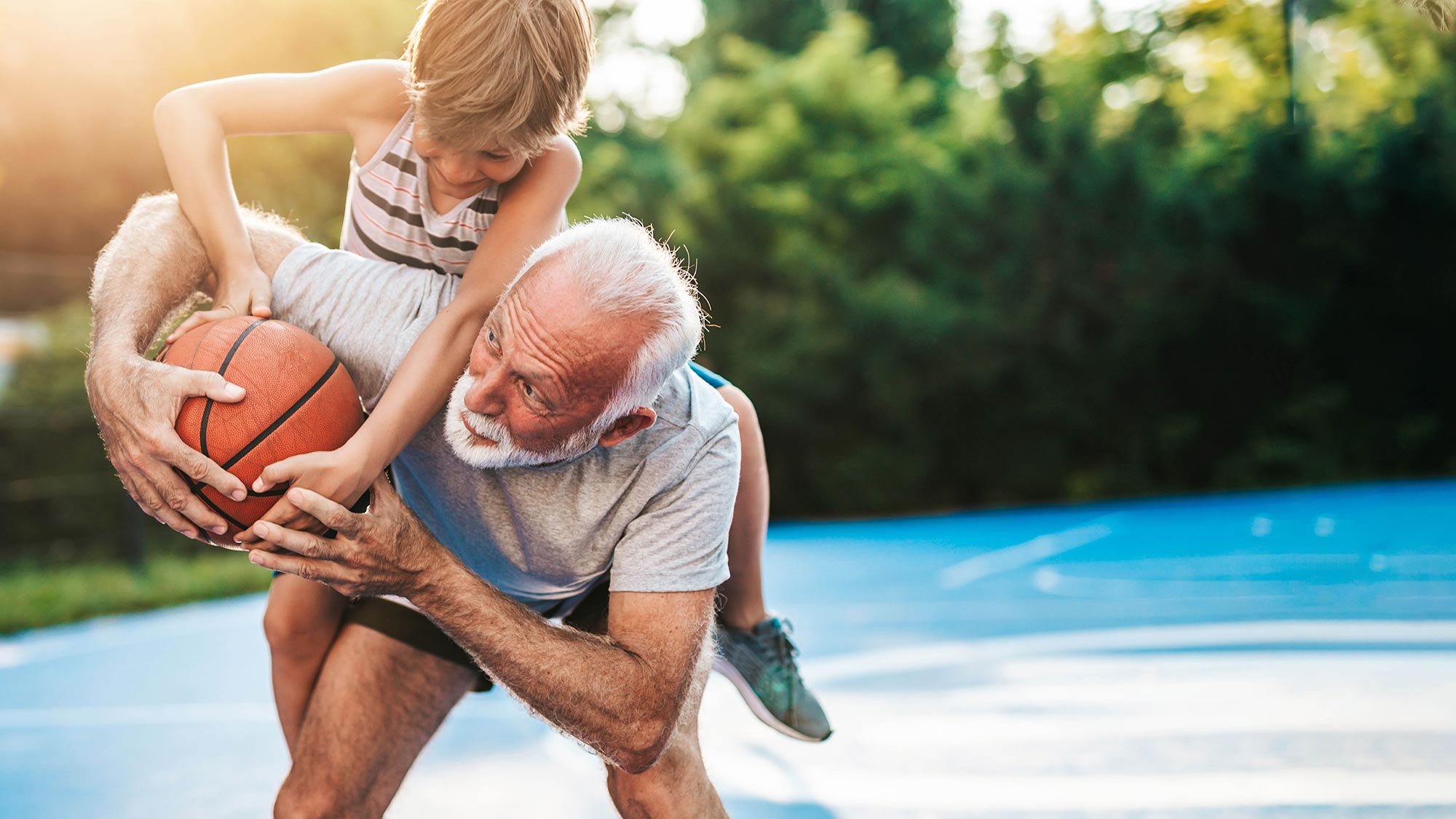 man and boy playing basketball